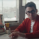 Jack Antonoff, symbolically turning away from a jukebox playing his own music.